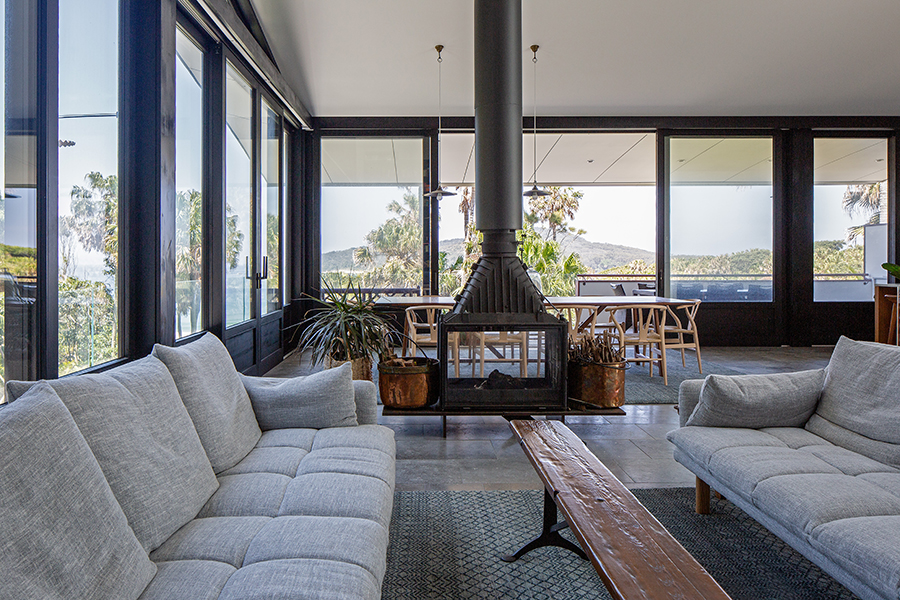 Internal view of home with fireplace, black double glazed timber windows with BAL-FZ Rating