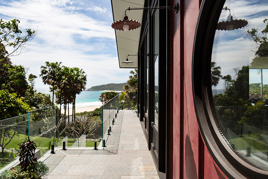 View of the house and surrounding gardens, with a double glazed custom made circular window in frame